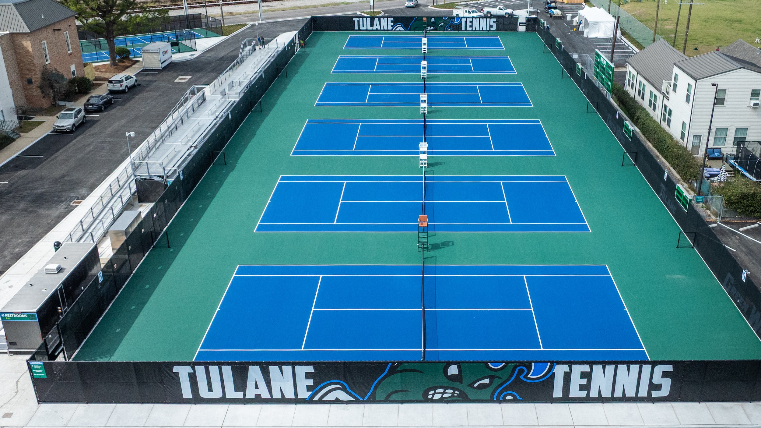 Aerial view of multiple blue and green Tulane University tennis courts.