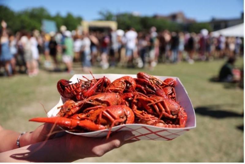 A photo of someone holding a basket of crawfish.