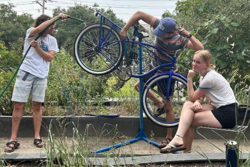 The Benevolent Society's Bike Help Desk An image of three people working on a bike.