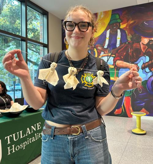DIY Ghost Garland An image of a person holding a festive garland.